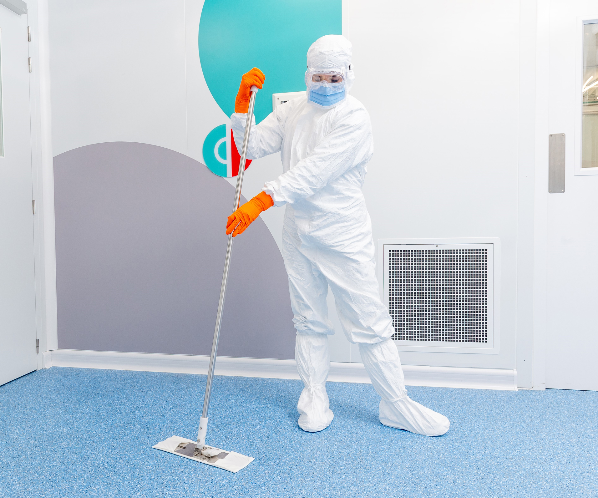 Image of cleanroom user mopping cleanroom floor