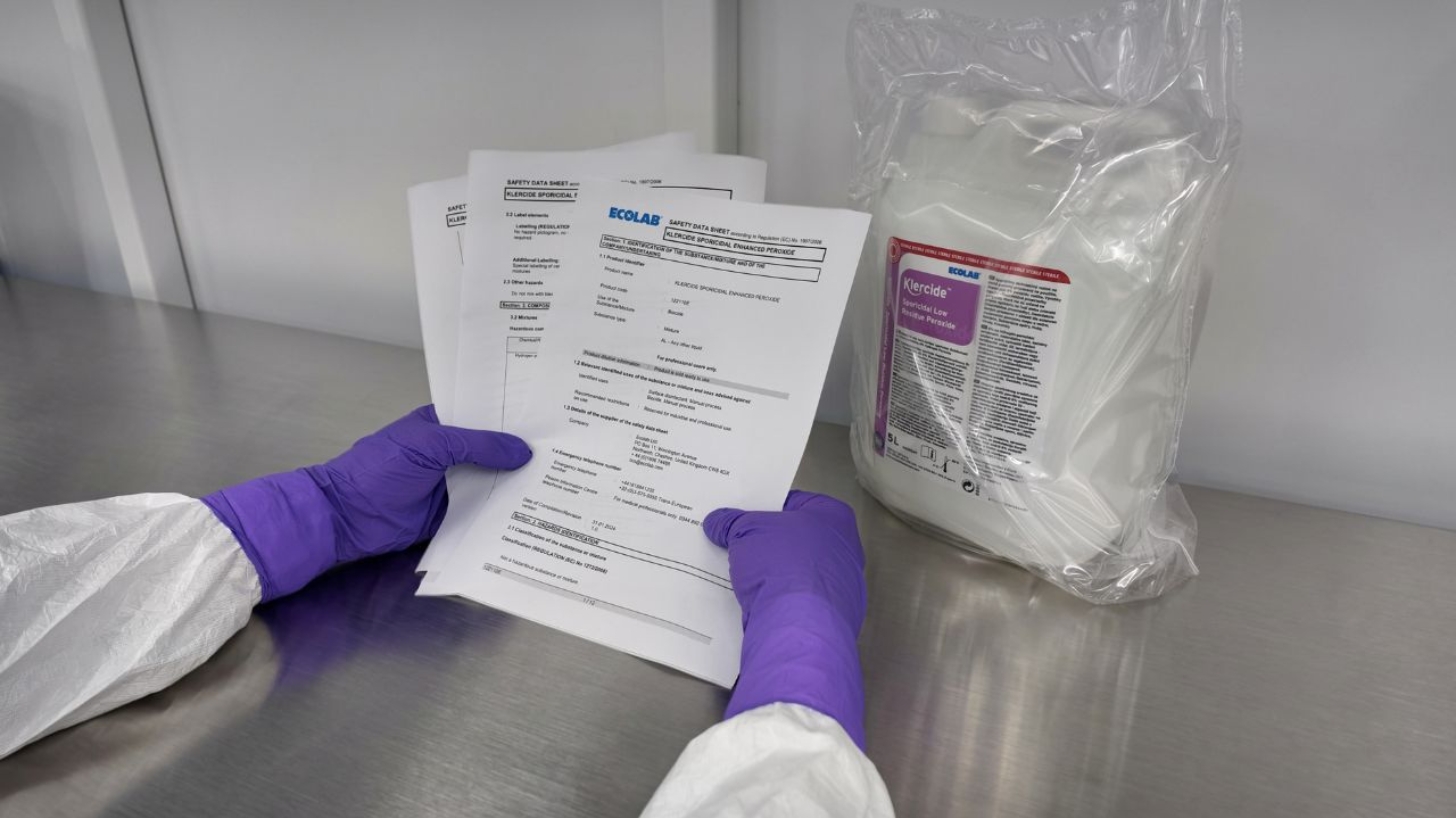 Cleanroom operator reading a safety data sheet